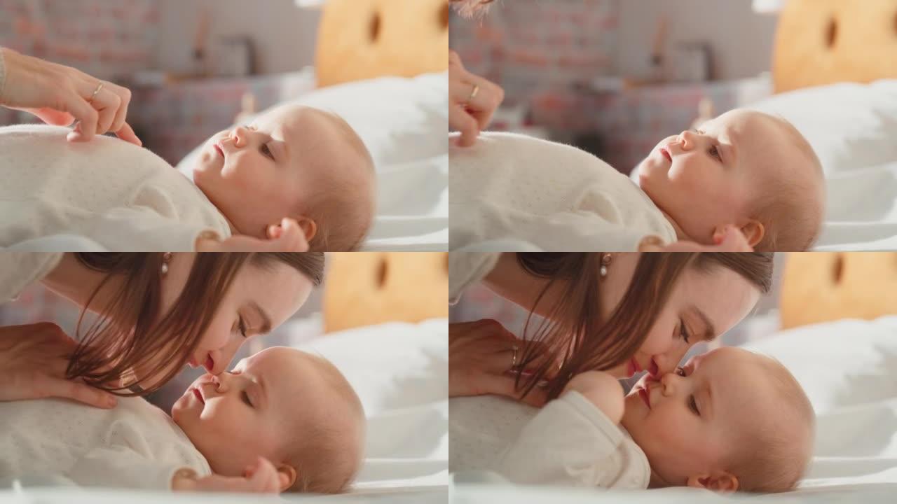 一位母亲与一个可爱的新生婴儿玩耍的特写镜头，该婴儿躺在舒适温暖的房间中的婴儿床中。妈妈和一个幼儿交往