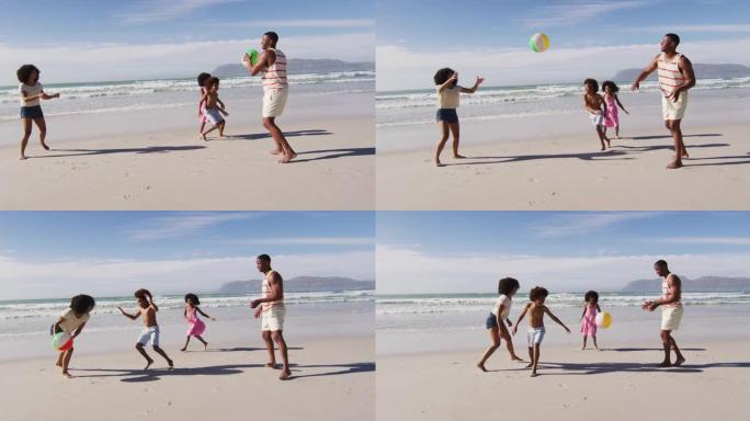 非裔美国父母和他们的孩子在海滩上玩球