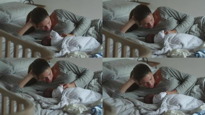 neo mother的真实镜头是母乳喂养，并在早晨在托儿所爱抚她的新生婴儿。