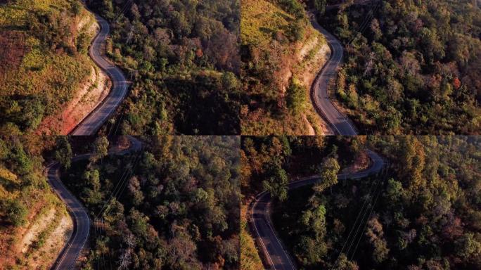 山和绿色森林上的道路鸟瞰图，旅行和汽车概念