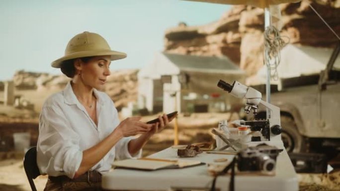 考古挖掘地点: 伟大的女性考古学家进行研究，使用智能手机扫描和分析化石遗骸，古代文明文化文物。历史学