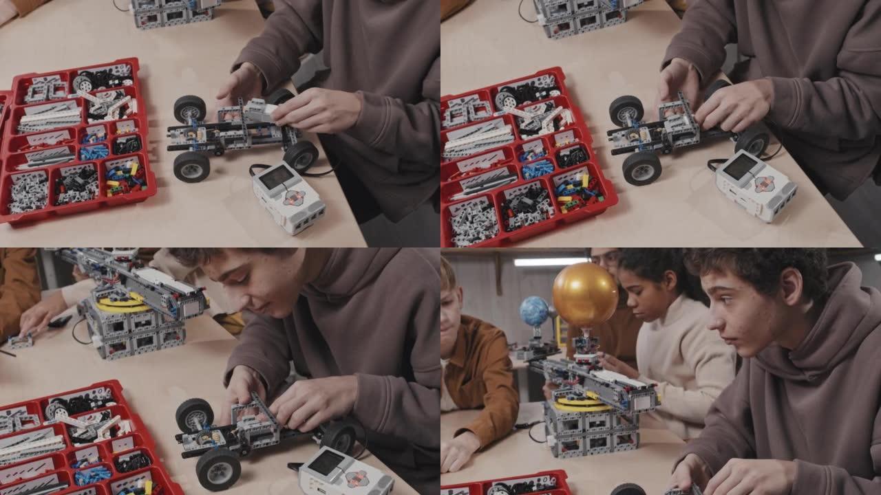 男孩用建筑套装建造汽车模型