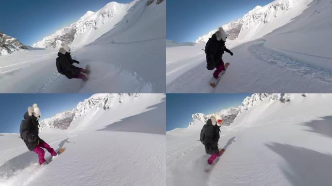 女滑雪者在刚下雪的山脉的怀抱中骑着粉末雪