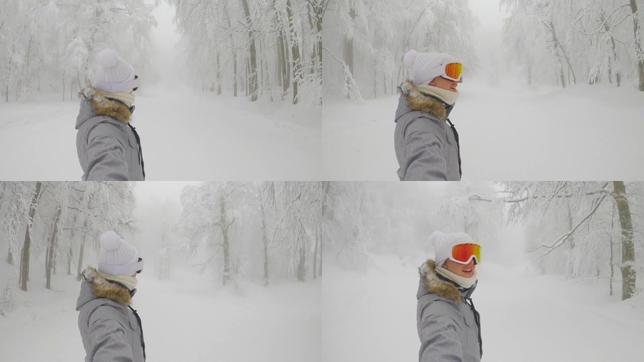 自拍照: 快乐的女滑雪者在空旷的斜坡上骑行时微笑。