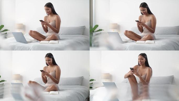 一名年轻女子在家中床上使用智能手机和笔记本电脑的4k视频片段