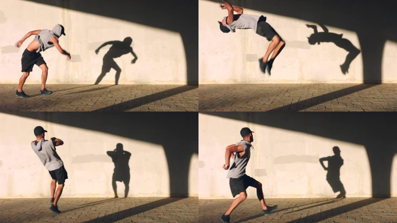 舞蹈、音乐和能量，一个男人舞者在外面跳舞训练和练习，他的影子在墙上。健身，自由和嘻哈，由年轻的男性表
