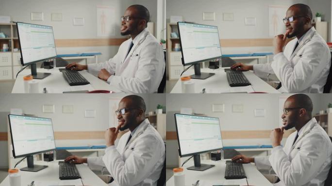 穿着白大褂的富有经验的非裔美国男医生在办公室用个人电脑工作。医疗保健专业人员处理测试结果，病人治疗计