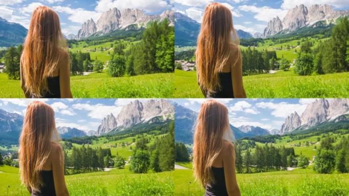 年轻女子与自然联系，在山腰欣赏迷人的景色