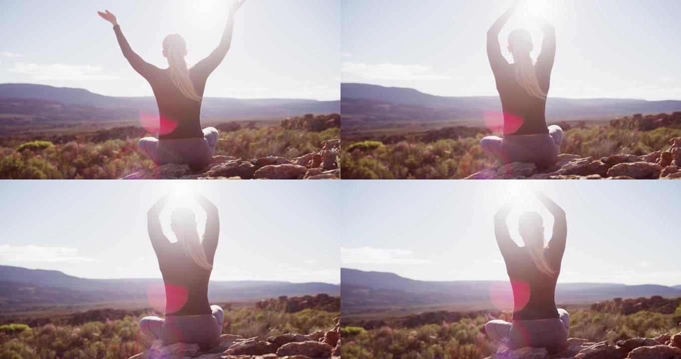 4k视频片段，一名年轻女子在山上冥想