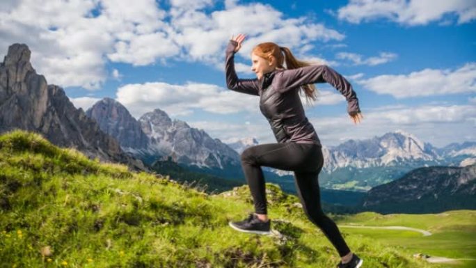 在意大利多洛米蒂山区的小径上奔跑的年轻女性