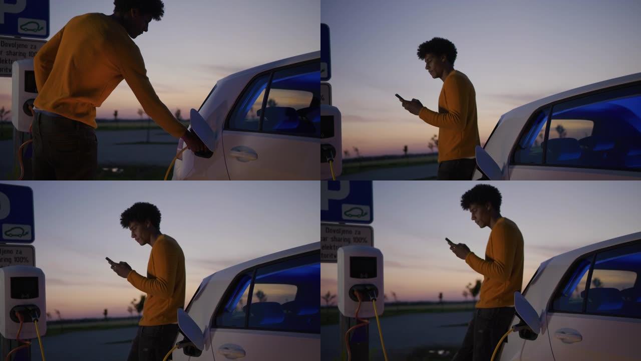 SLO MO Young man在黄昏时在停车场用蓝色能量向他的电动汽车充电
