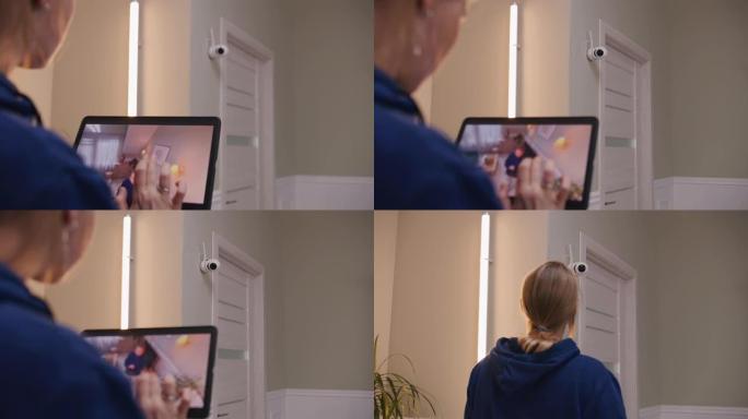 女人使用平板电脑设置闭路电视摄像机