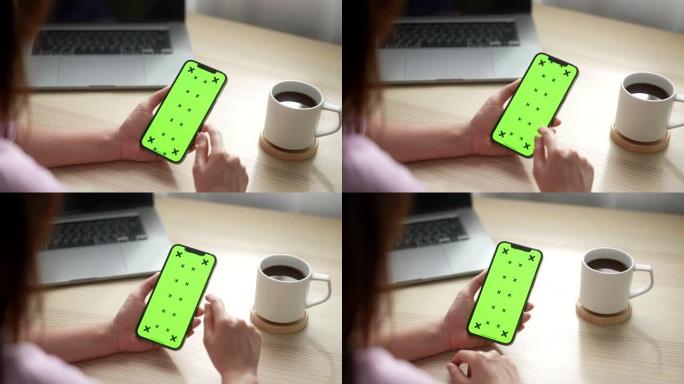 使用绿屏智能手机的特写女性