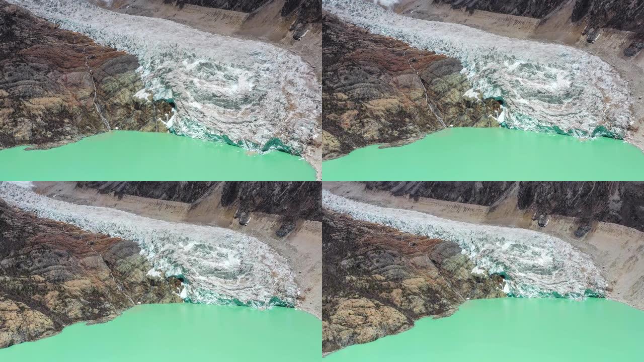冰川从山顶涌入绿色的高山湖泊