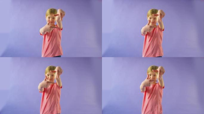 工作室拍摄的女孩用手在紫色背景下制作相框的形状-慢动作拍摄