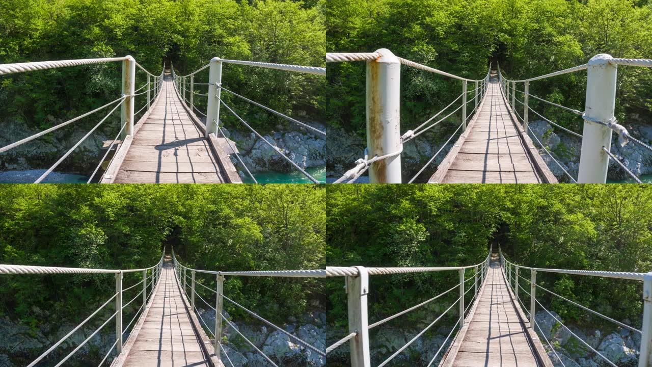穿越绿松石河上的木制吊桥