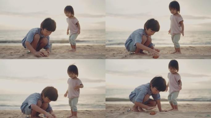 亚洲兄妹在沙滩上玩沙子