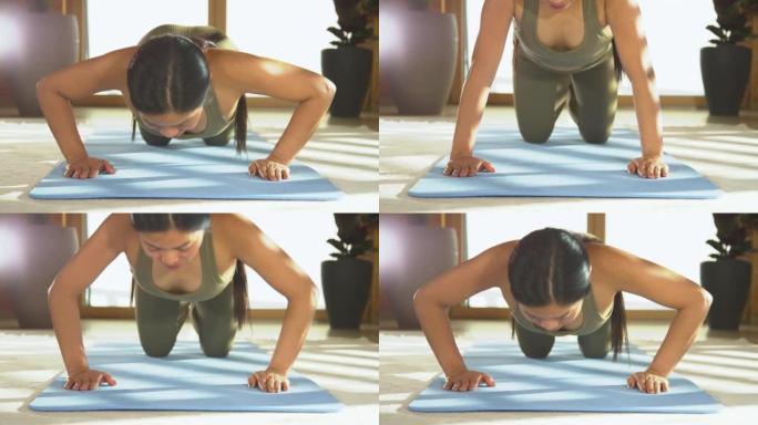 特写: 年轻的亚洲女士在健身锻炼中做俯卧撑以增强手臂力量