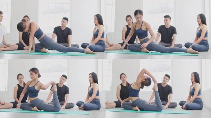 亚洲女教练在瑜伽课上展示高级瑜伽练习