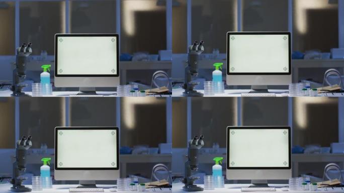在空实验室的工作站上带有照明屏幕的台式计算机