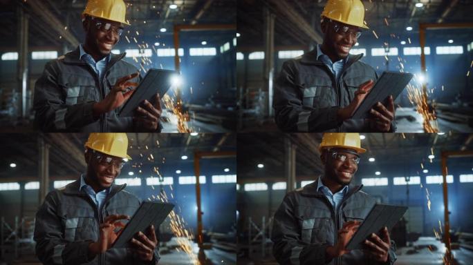 专业重工业工程师/穿着安全制服和安全帽的工人使用平板电脑。微笑的非洲裔美国工业专家站在金属建筑制造商