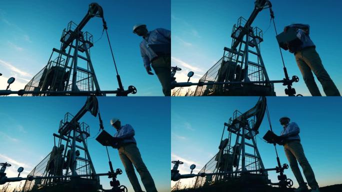 石油工人监控原油泵千斤顶。石油行业，原油价格概念。