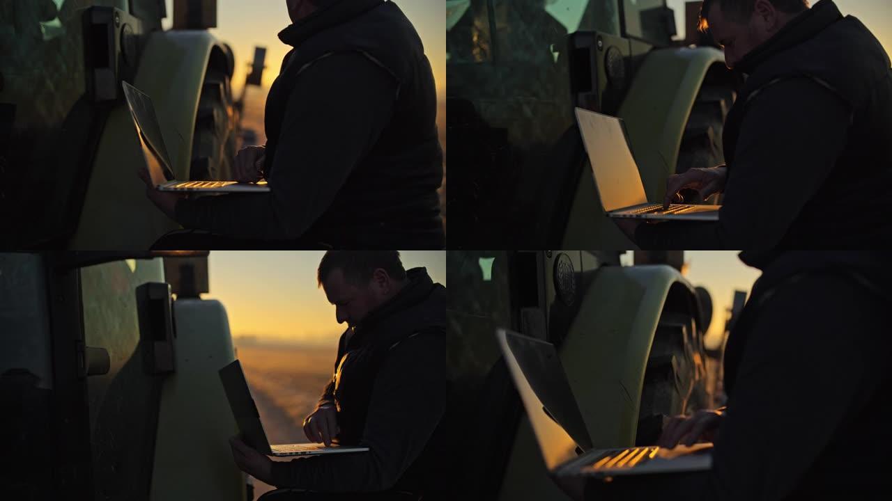 男性农民在日出时在寒冷的农村地区的笔记本电脑上工作