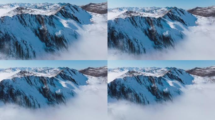 中国四川夹金山山谷中浮有雾云的空中雪山景观