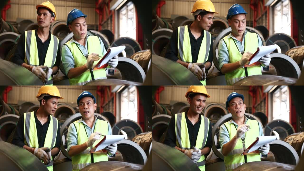 两名头戴安全帽的仓库工人检查制成品
