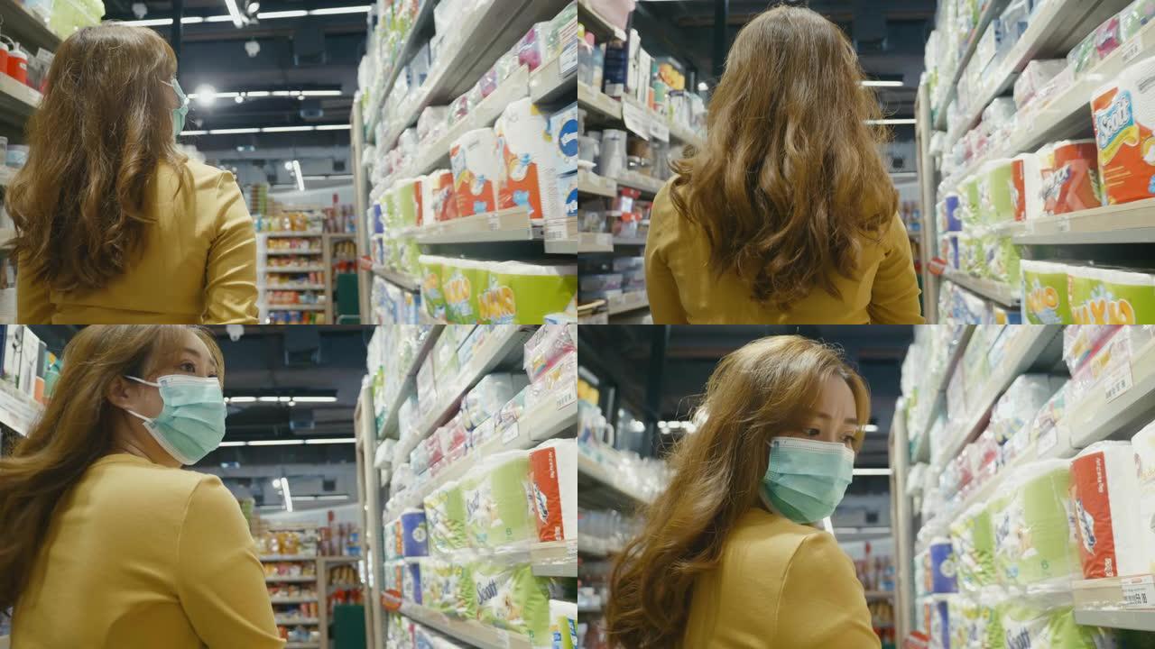 戴着面具在超市购物的年轻女性。