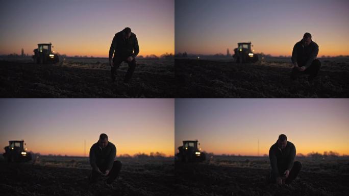 日出时，农民在农田里检查土壤