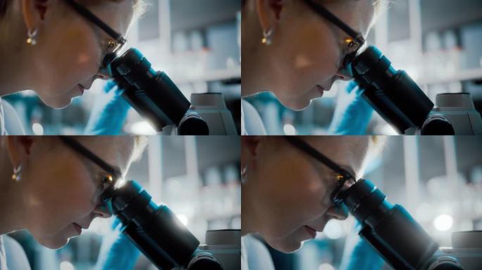 在明亮的医学科学实验室: 美丽的微生物学家戴着眼镜在显微镜下观察分析样品。杰出的科学家，医生，使用高