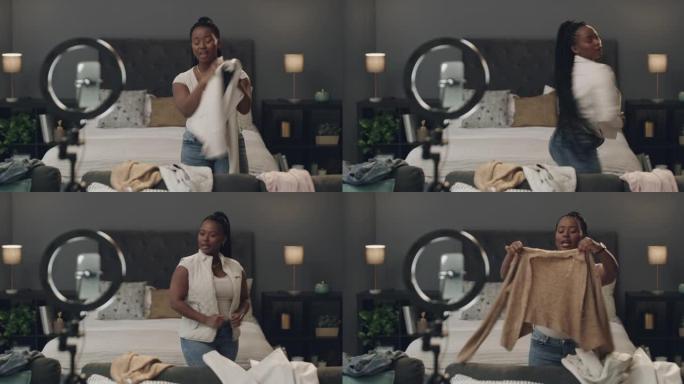 4k延时镜头，一名年轻女子在舒适的卧室里使用手机和照明环为她的vlog试穿衣服
