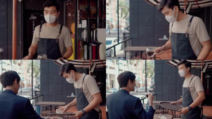 亚洲服务员戴着防护面具，为顾客提供咖啡和问候。