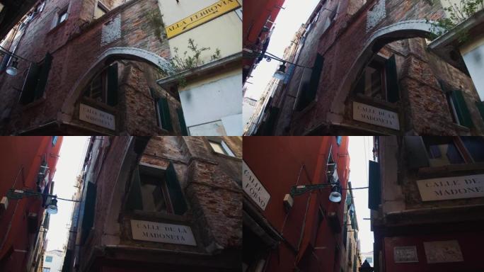 电影背景拍摄，低角度相机沿着美丽的老狭窄街道移动，在意大利威尼斯有惊人的标志。