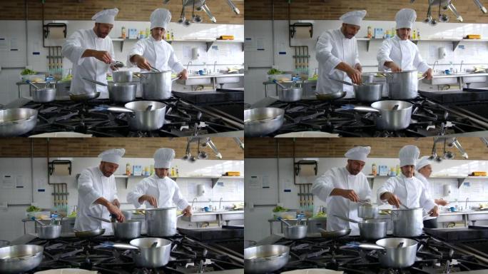 男厨师在一家商业厨房工作，非常专注地准备不同的盘子