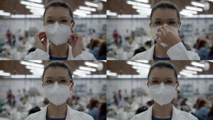 在纺织厂工作的年轻女子戴上防护口罩