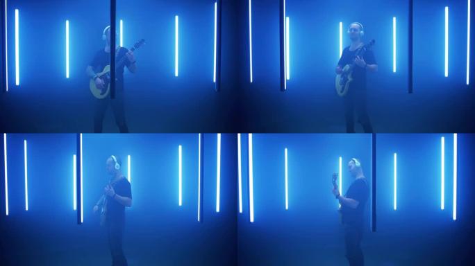 男性摇滚歌手在蓝灯圈弹吉他