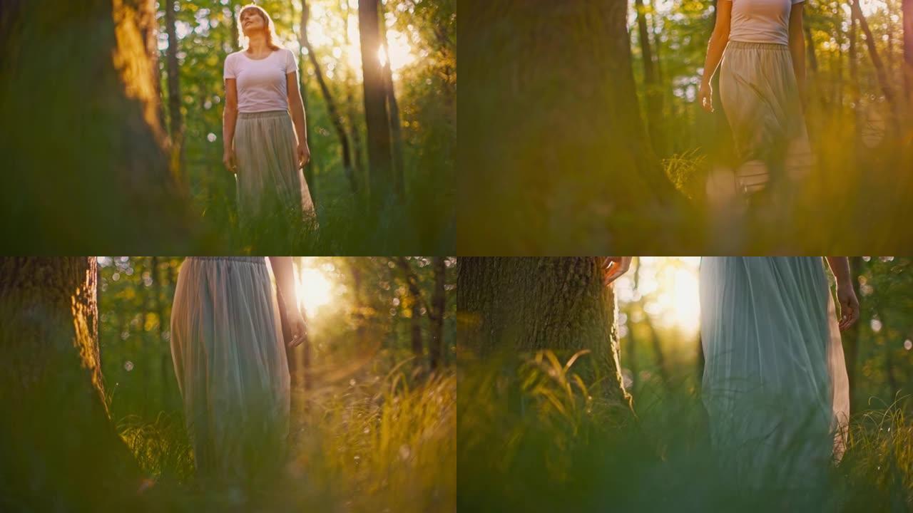 穿着白色长裙的SLO MO女人赤脚在高高的草丛中行走时碰到树木