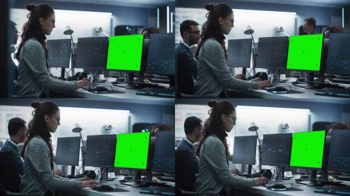 女性软件开发人员在具有绿屏模拟显示的台式计算机上工作。忙碌的专家在键盘上打字，编码和实施新技术功能，