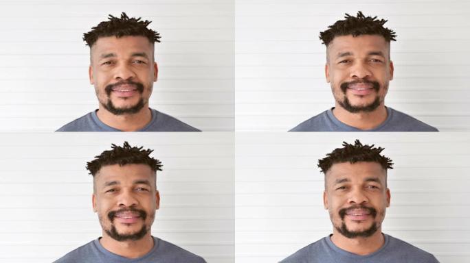 年轻黑人男子微笑着自信的肖像看着相机独自在家摆姿势，带着快乐的心情享受成功的生活方式。家庭工作室