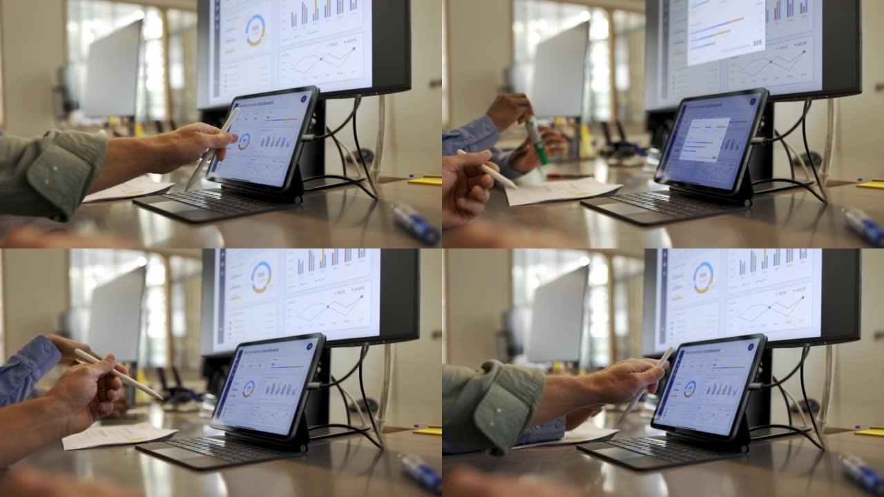 办公室专业人员在数字平板电脑上分析图表