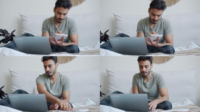 雄心勃勃的阿拉伯男子自由职业者在网上工作，使用笔记本电脑在床上写字