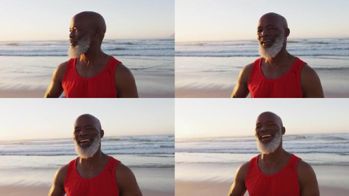 微笑的非裔美国人老人在沙滩上散步