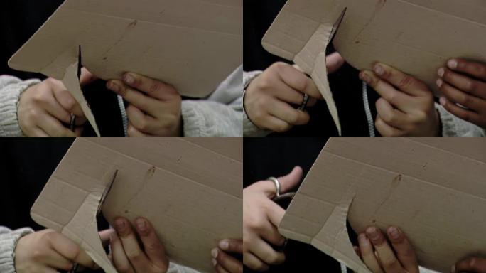 在阿根廷的一所公立学校的艺术课上，小学生切纸板。特写。