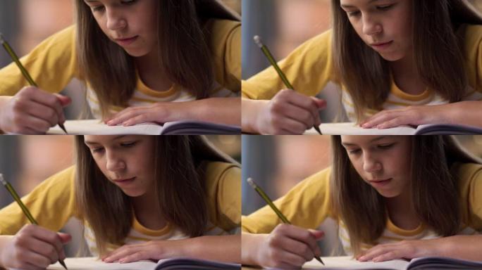 一个年轻女孩独自坐在家里做作业的4k视频片段