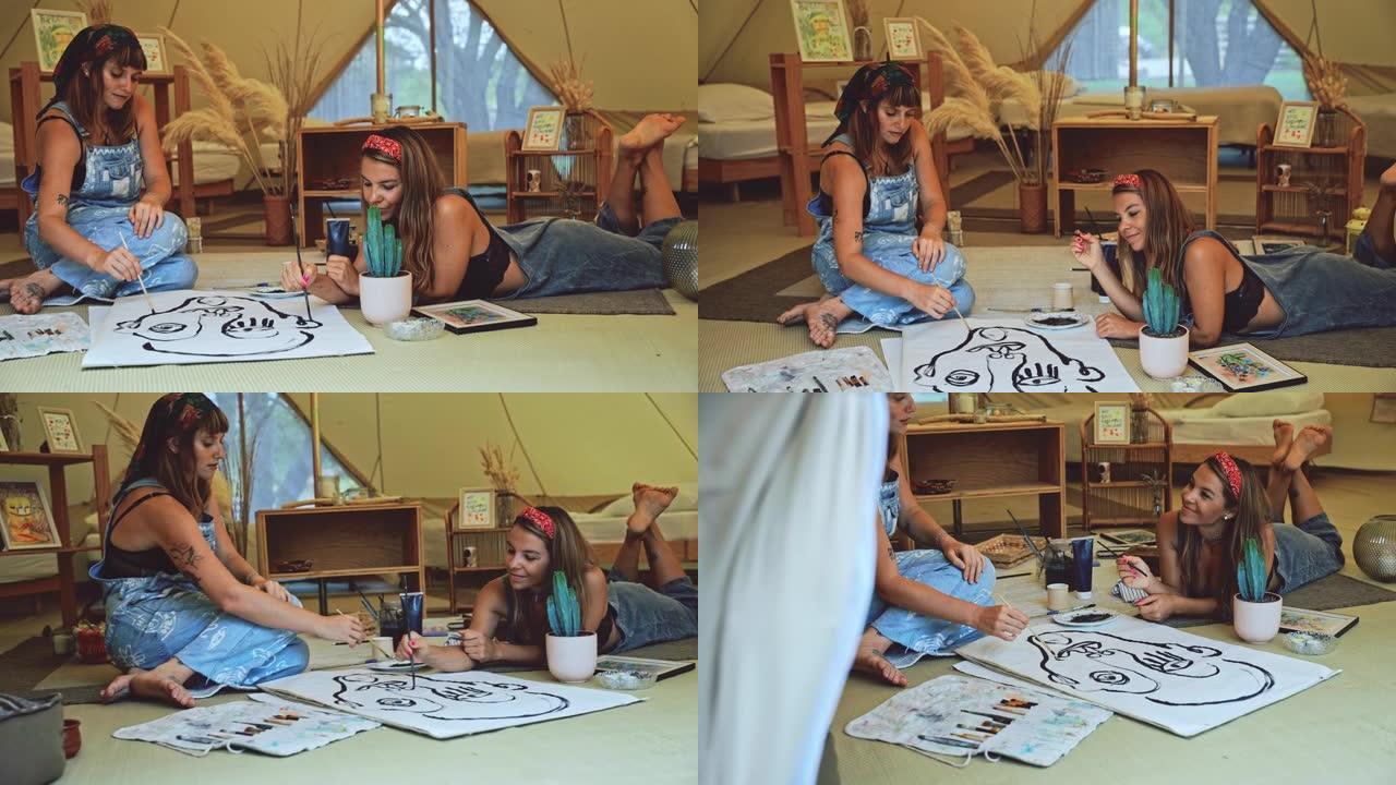 SLO MO两个年轻女人在帐篷里画画很有趣