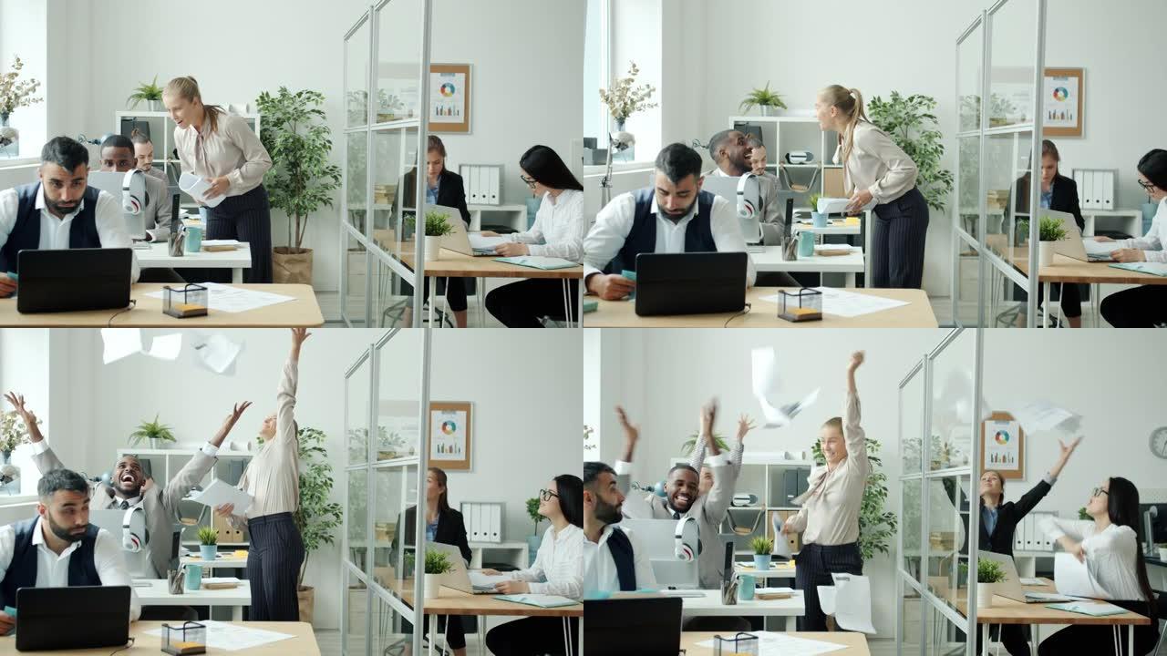 快乐的女人与同事交谈，得到好消息，在办公室扔报纸和跳舞