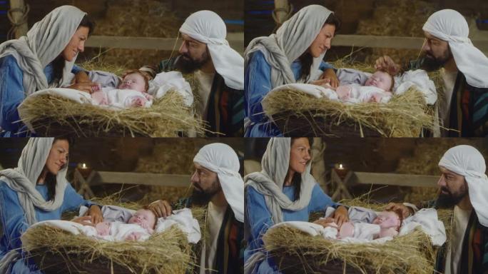 玛丽和约瑟夫在马槽里与小耶稣说话