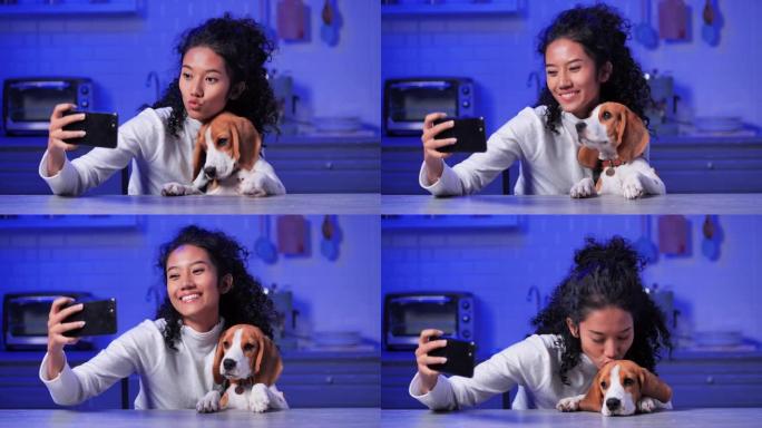 在使用智能手机和视频会议技术进行社交距离期间，在家里的厨房里，视频会议上有一只小狗的美丽的十几岁的黑